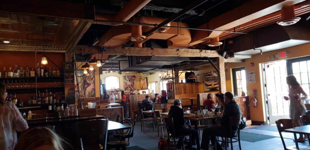 People eating inside a rustic wooden restaurant.