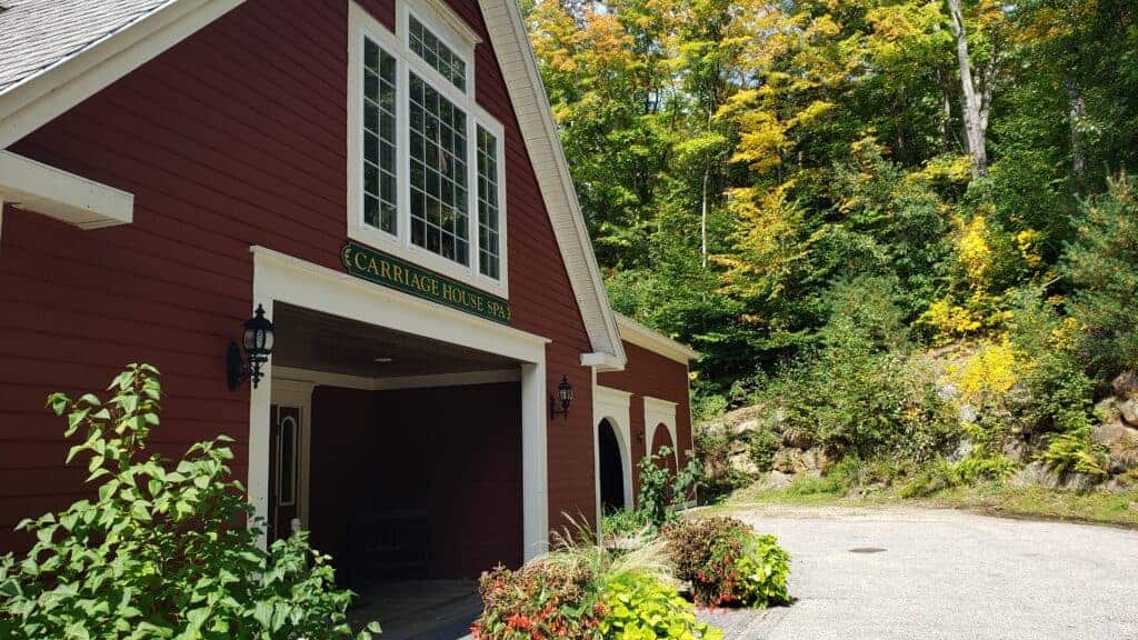 Red New England style house with white trim