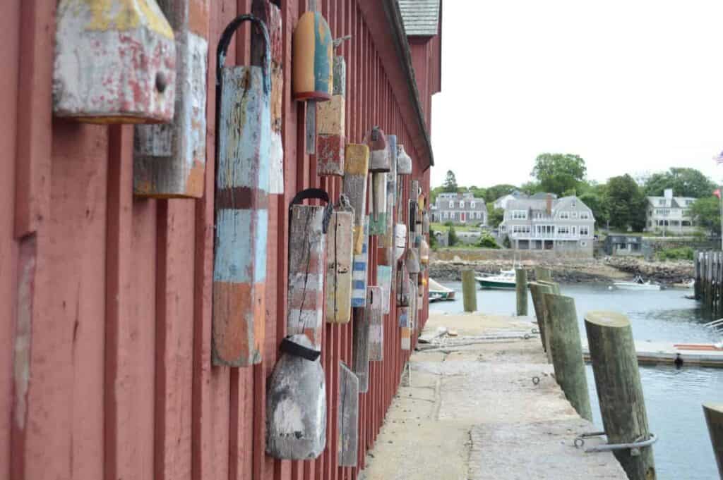 A building covered with papers next to a dock 