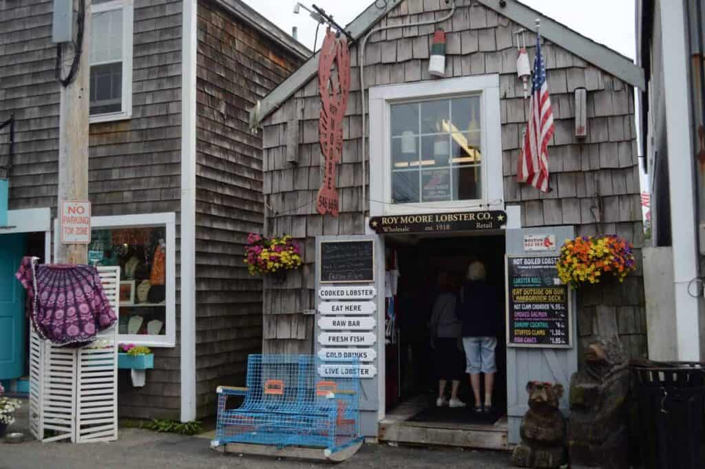 A grey building with flags hanging on each side