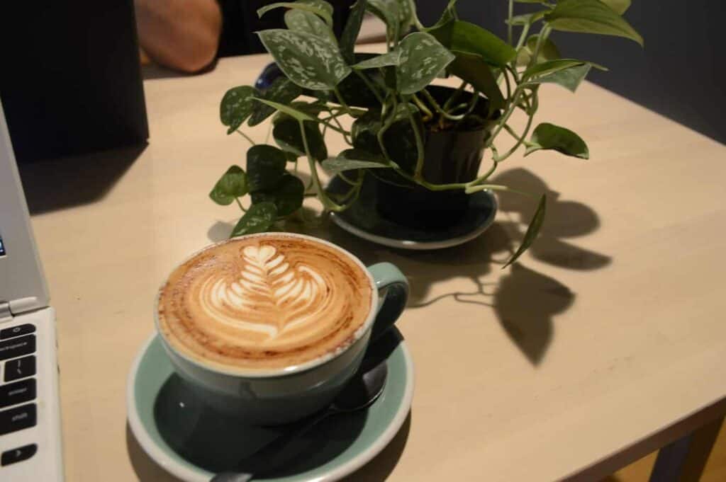 A cup of coffee on a table with latte art in Burlington VT.