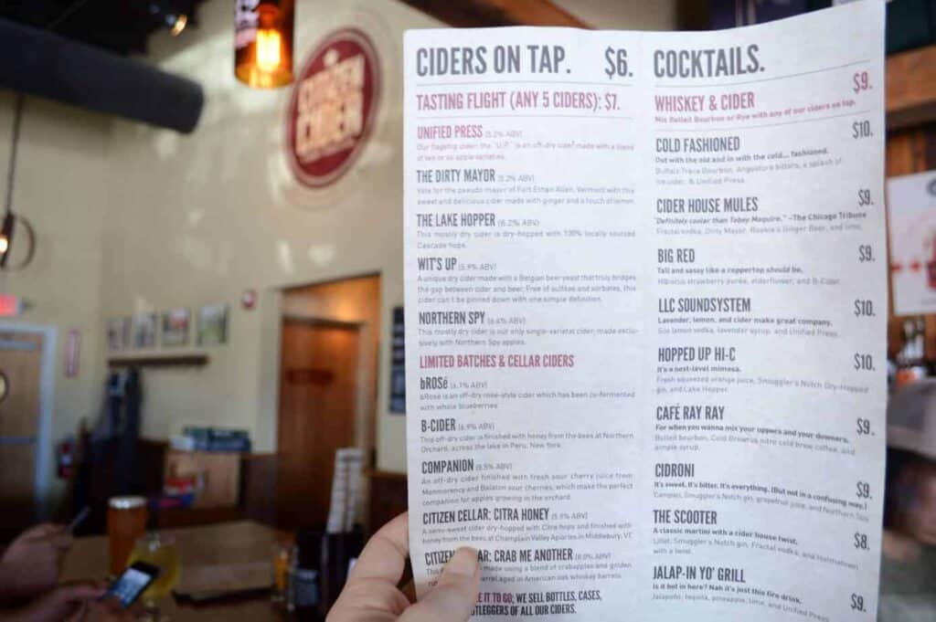 A printed menu is seen closeup featuring ciders and cocktails available at a brewery in Burlington Vermont