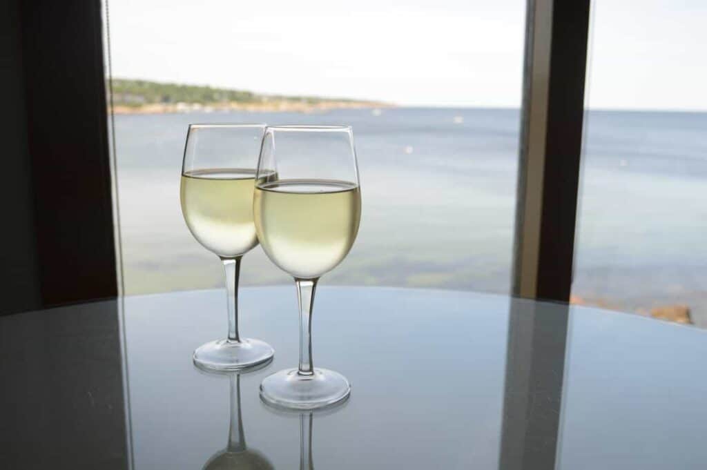 Two glasses of white wine with an ocean view