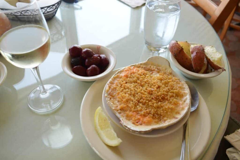 A bowl of food on a plate with side dishes