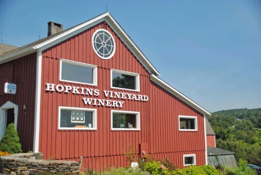 Red barn-like building with large windows that says \"Hopkins Vineyard Winery.\" is one of the top Litchfield Hills activities