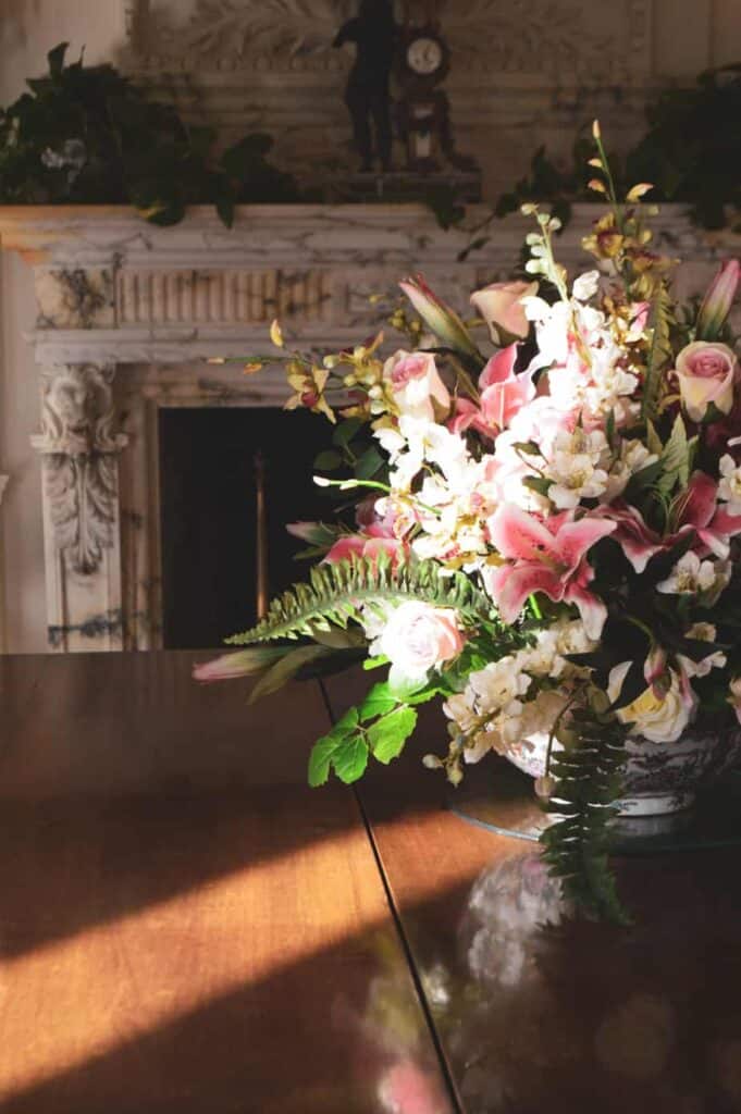 A bouquet of flowers with a fireplace in the background
