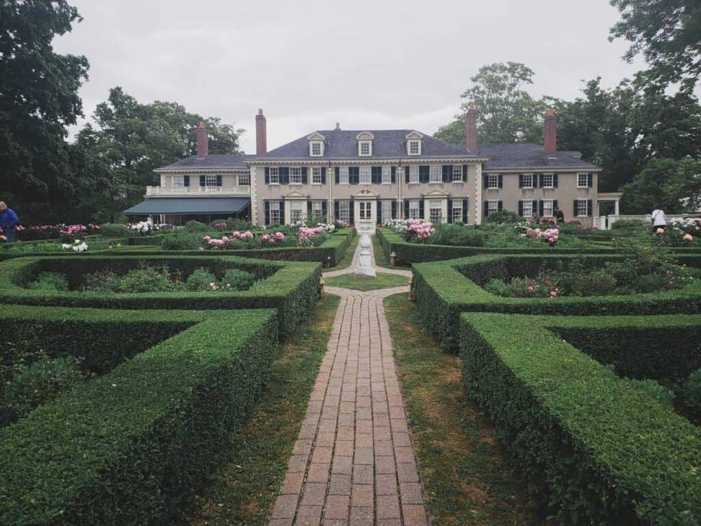 Manicured hedges along the path leading to a mansion in Vermont