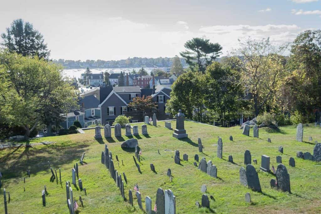 Graveyard on a lawn overlooking a town