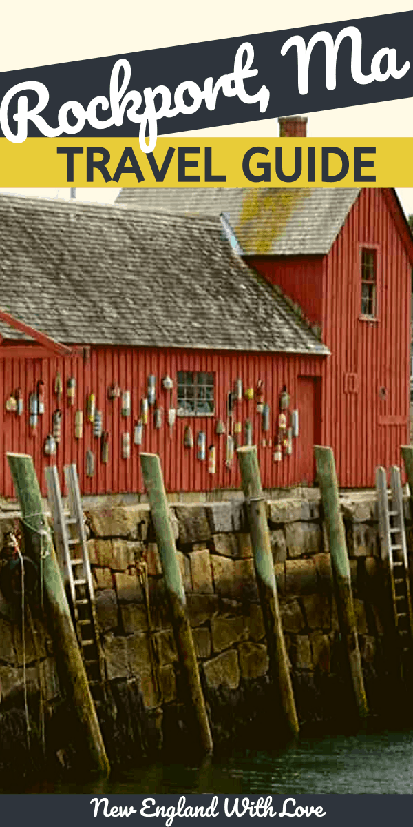 The side of a red barn next to water