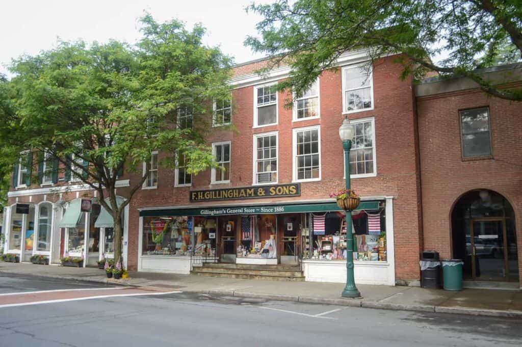 A large brick building with a store on the ground floor in Woodstock Vermont