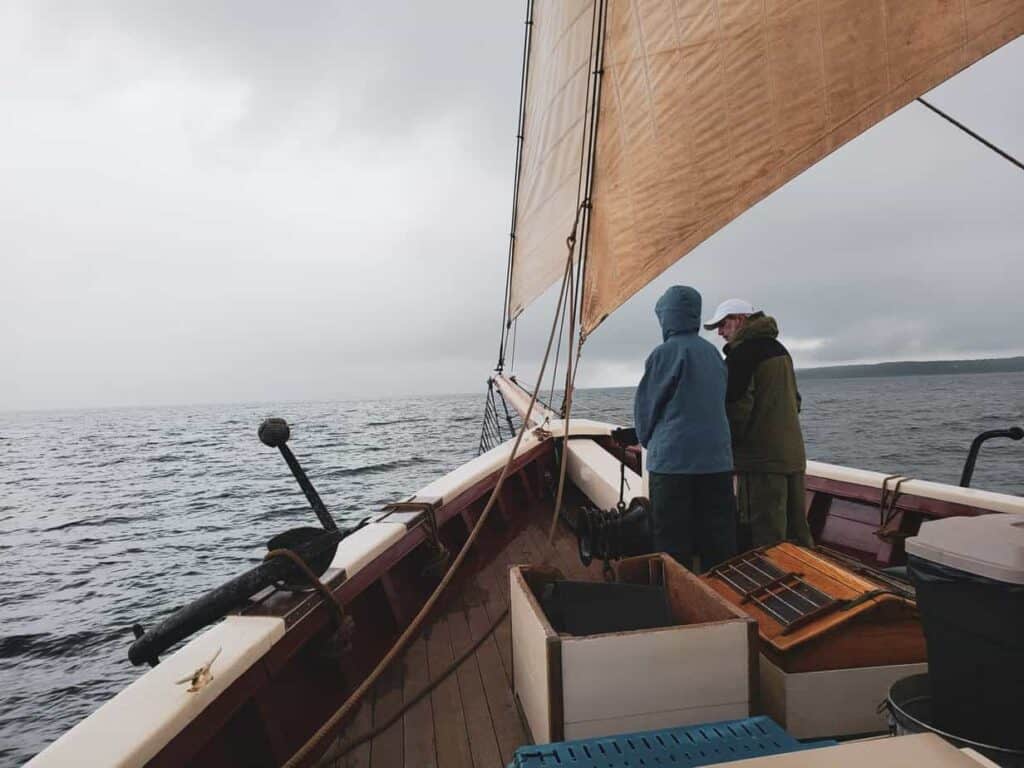 A group of people in a boat on a body of water