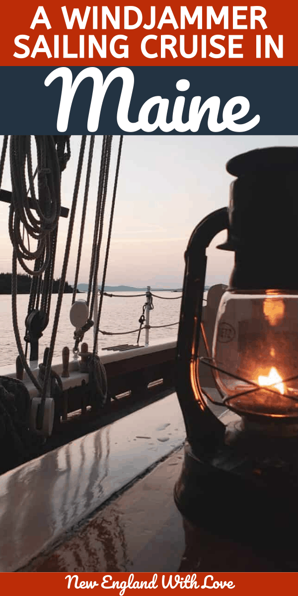 Lantern lit with fire sits on a table on a boat, with water in the background.