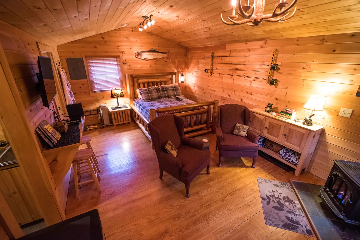 Paneled room with furniture and a small window in a vacation rental in the White Mountains of New Hampshire