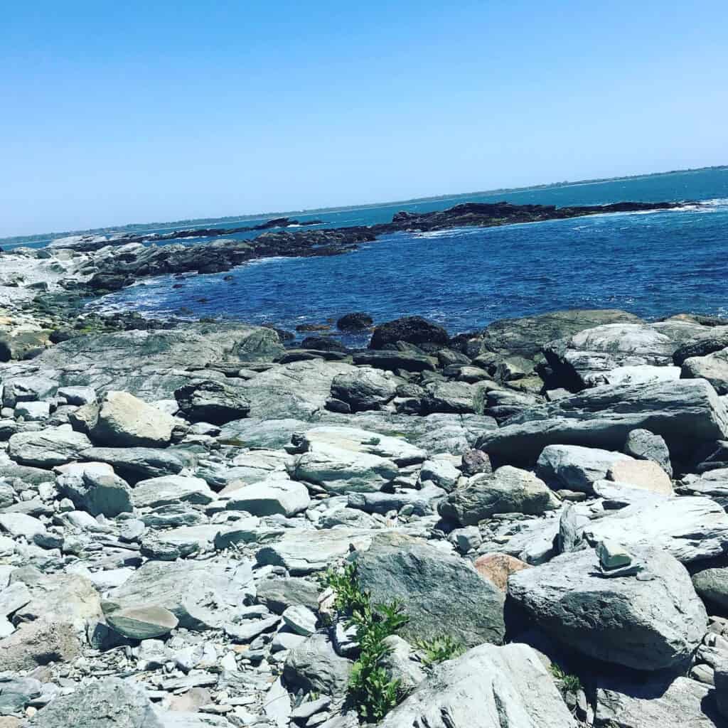 A rocky coast next to blue water