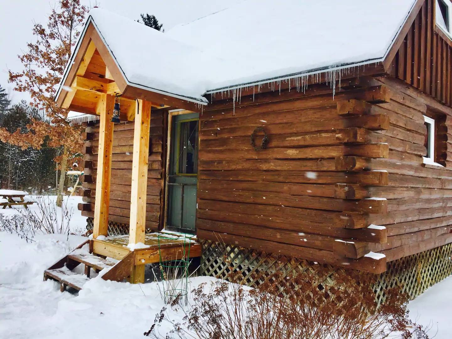 Exterior of wooden cabin covered with snow