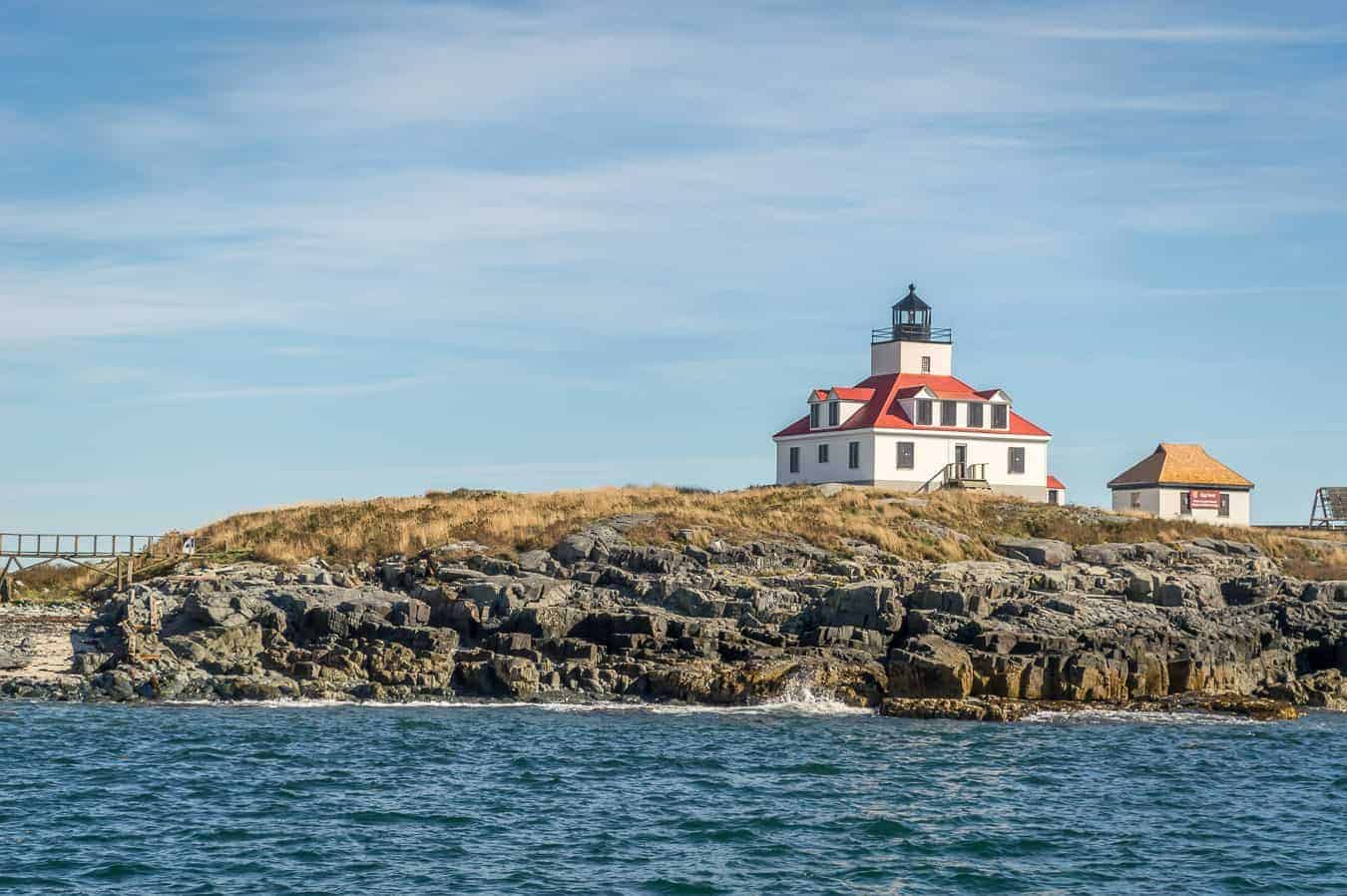 where to stay in acadia national park and bar harbor - image of square lighthouse on rocky ledge