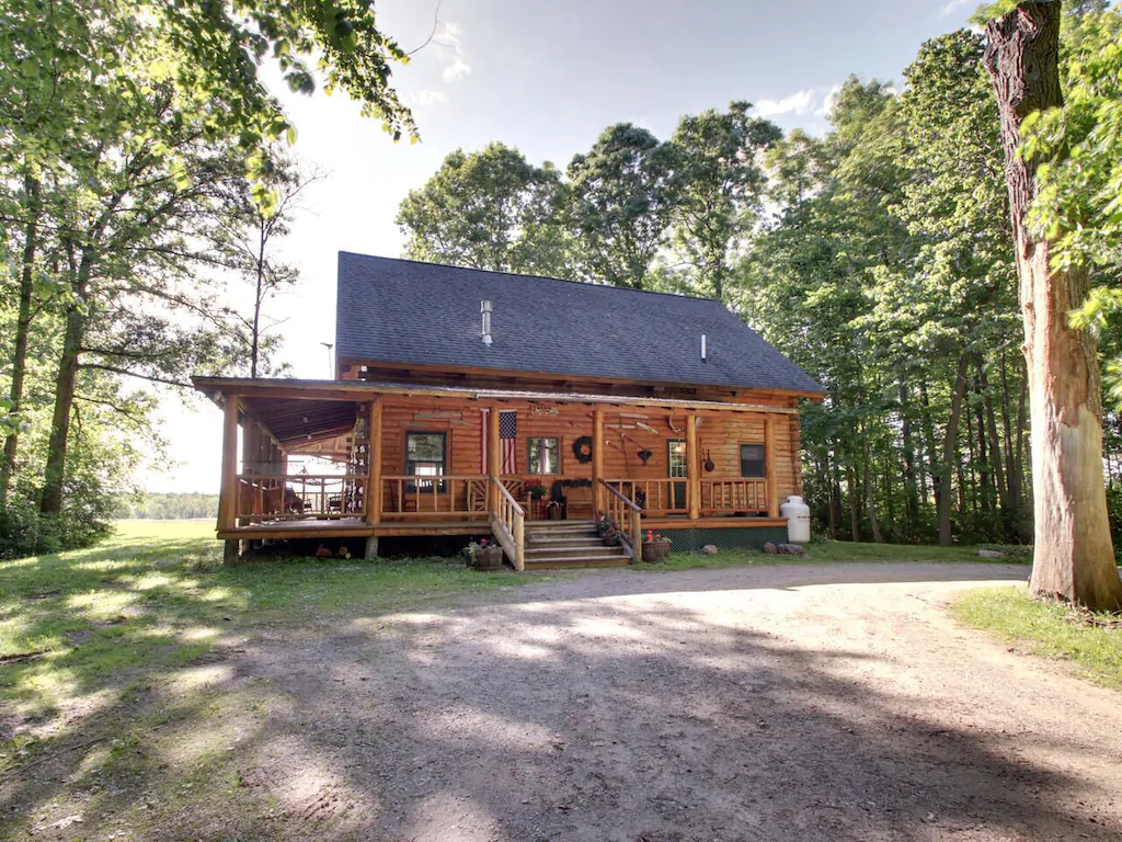 Exterior of a log cabin on a summer day in Vermont