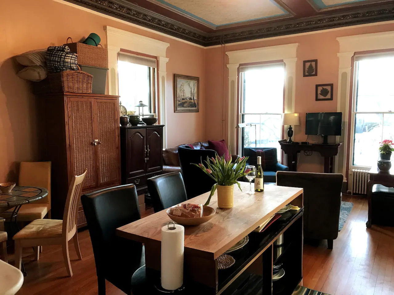 A dining room table with black leather chairs