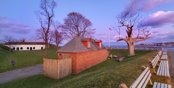 A historical fort surrounded by a wooden fence
