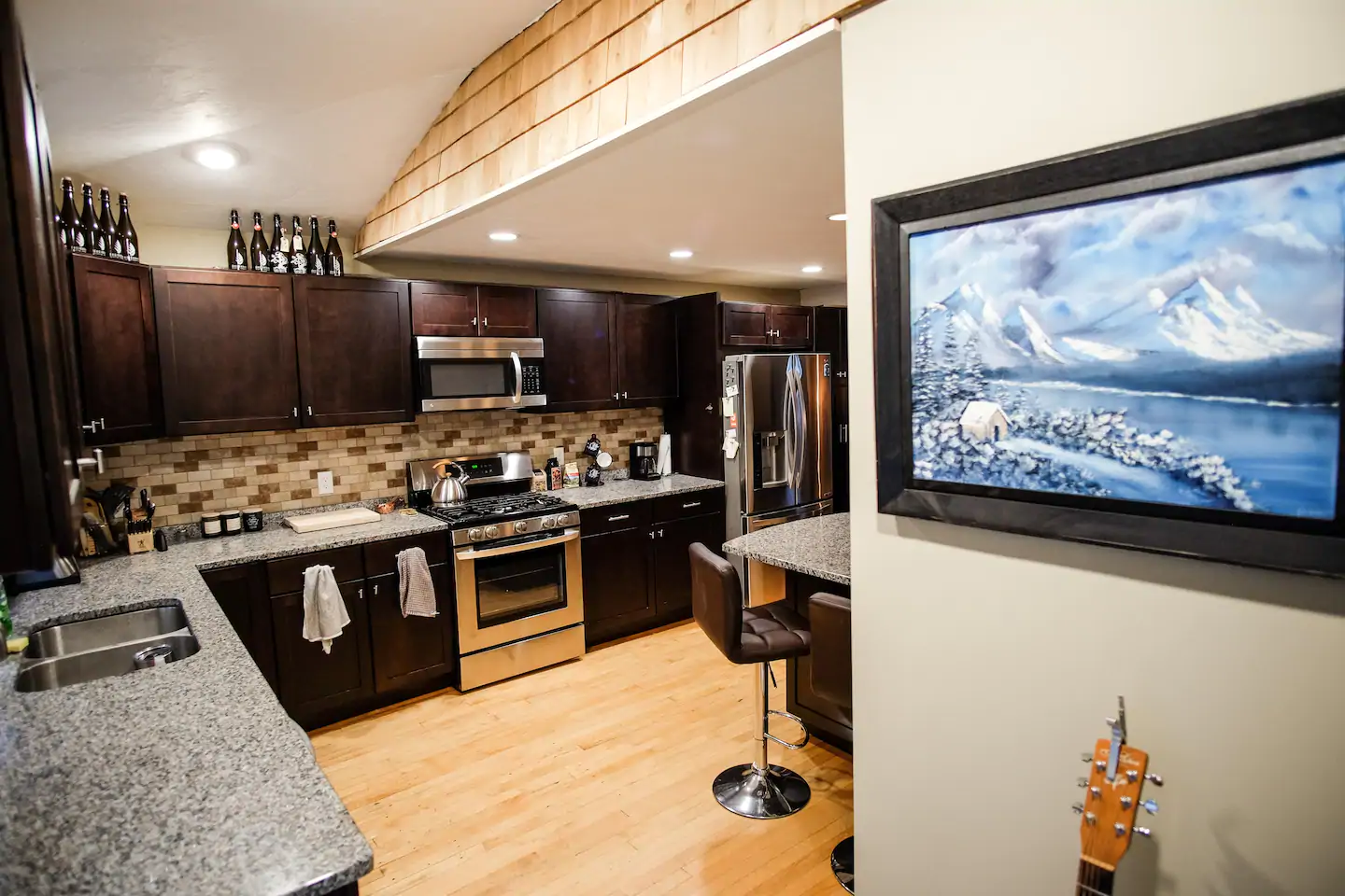 A modern kitchen with stainless steel appliances and wooden cabinets