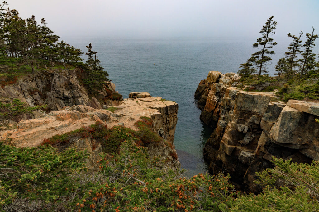 Steep and rocky cliff with a body of water below