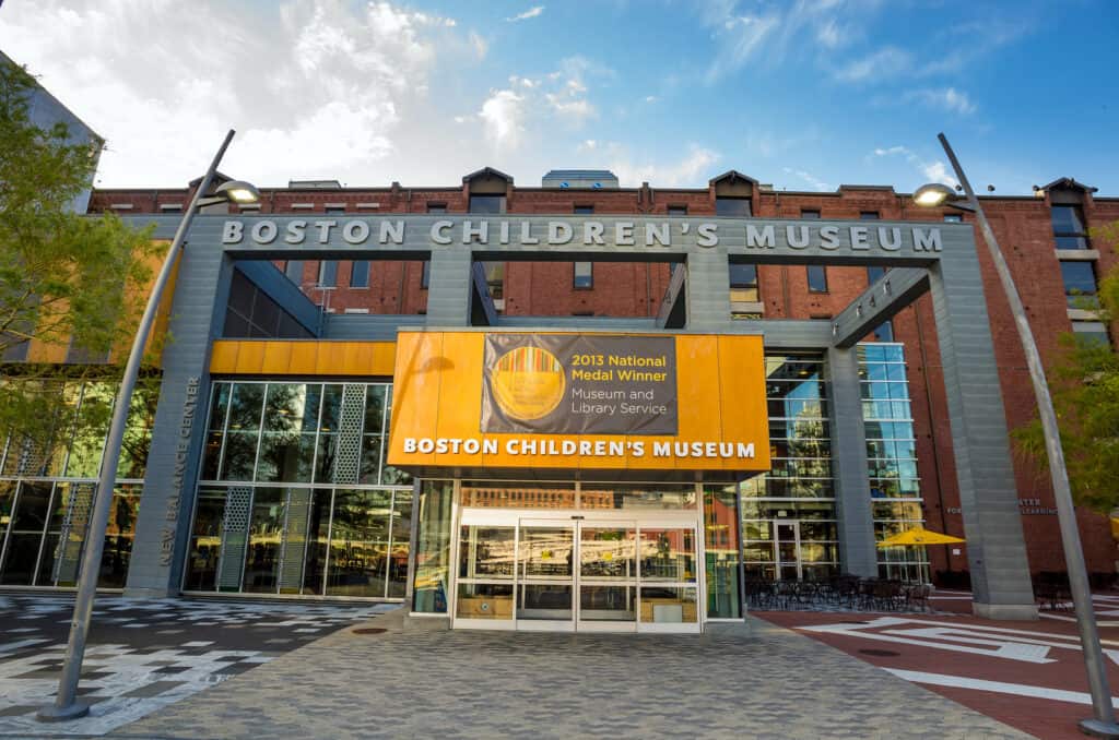 Museum that says, \"Boston Children\'s Museum,\" under a blue cloudy sky in Massachusetts.