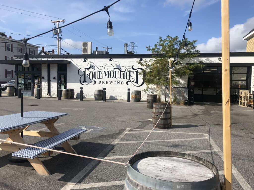 A white building with a sign reading "Foulmouthed Brewing"