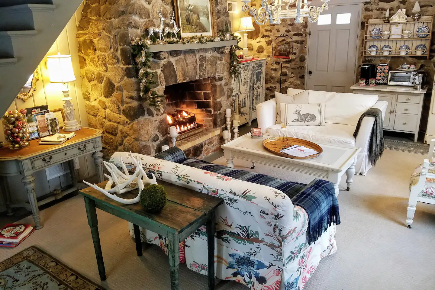 Pretty blue living room sofa with stone fireplace