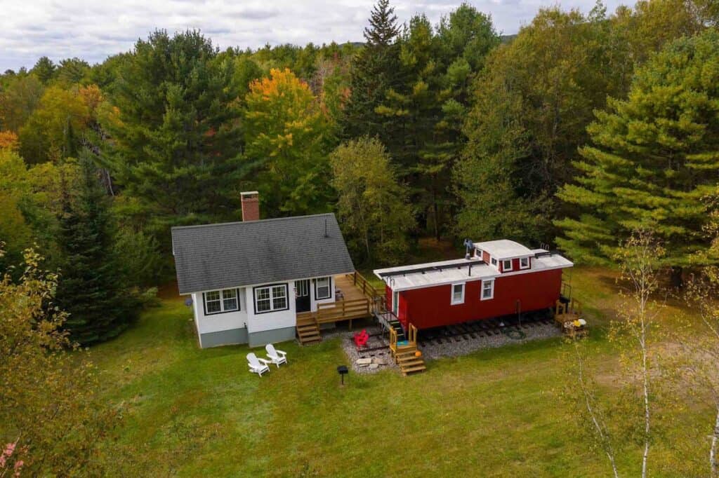 Aerial view of two buildings next to the woods