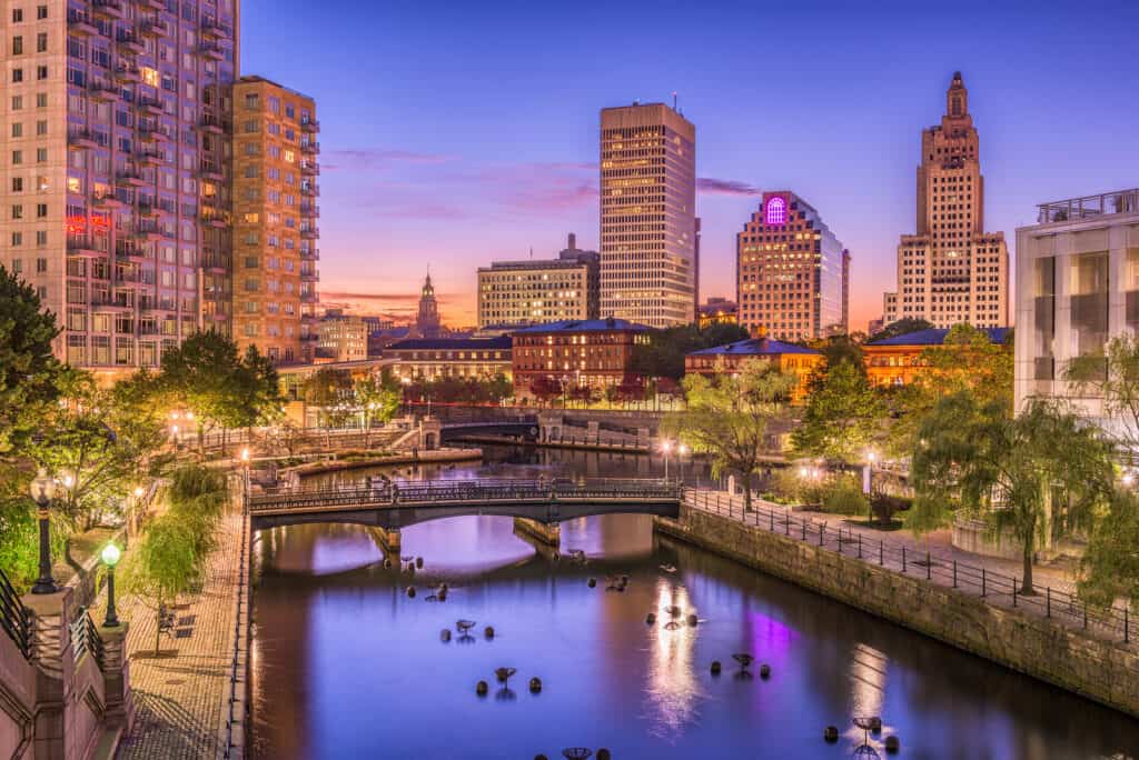 A bridge spanning a body of water with city buildings in the background