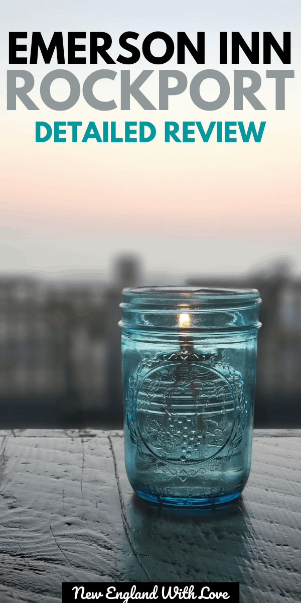 Candle lit inside of a blue glass mason jar. The sun is setting in the background.