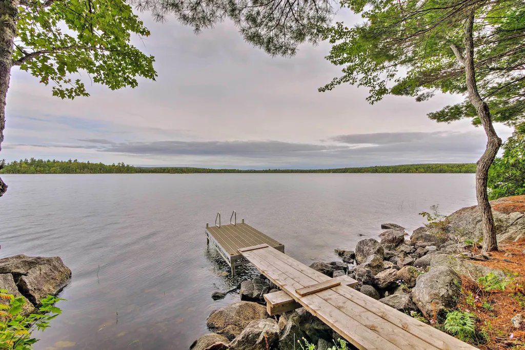 Wooden pier leading into a body of water with mountains in the distance