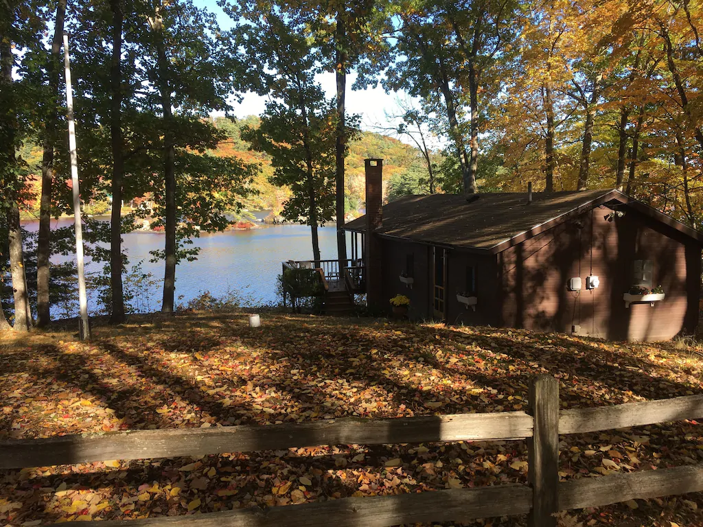 A cabin next to a lake