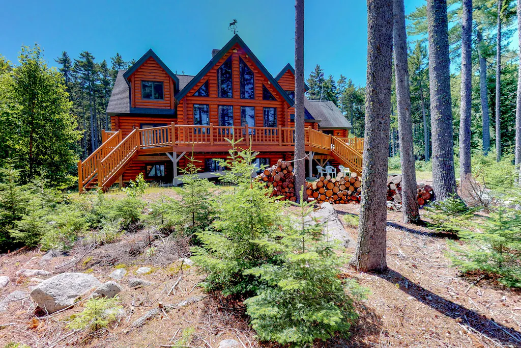 A path with trees in front of a very large chalet