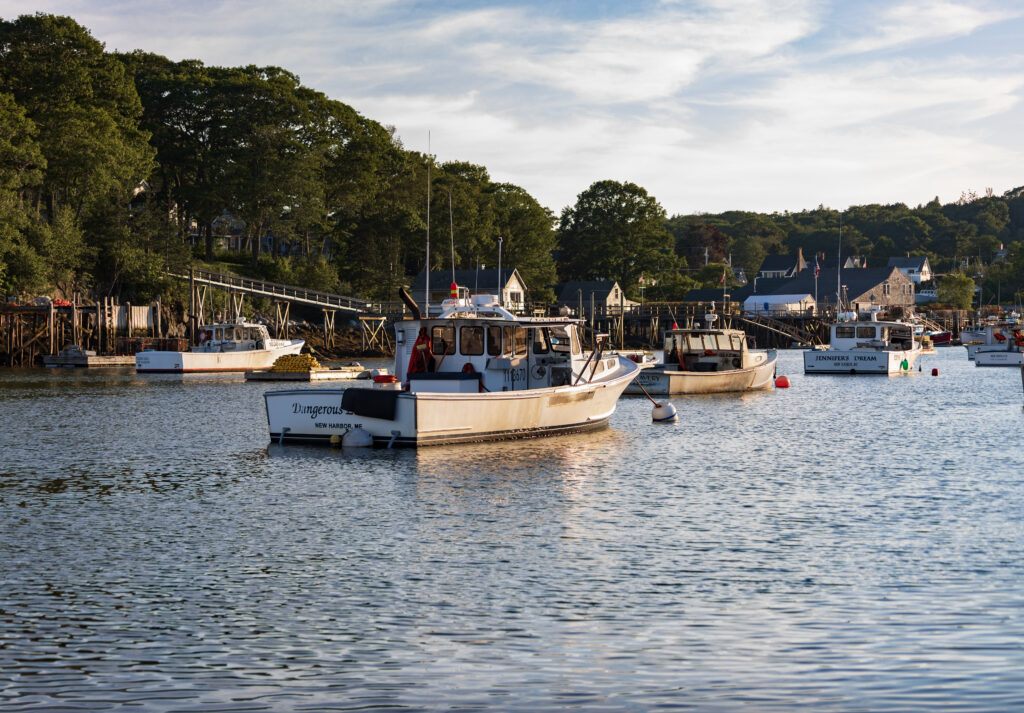 Boats floating on the water under a blue sky.