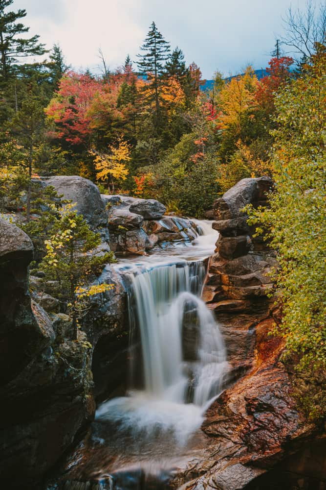 Waterfall surrounded by fall foliage.