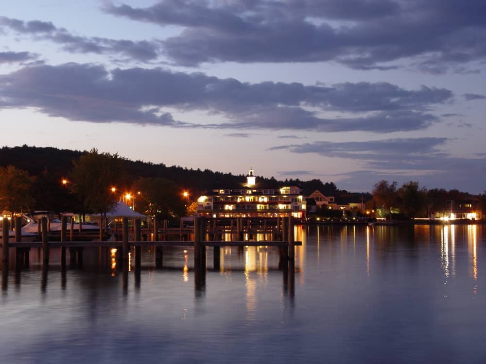 A large body of water with a city in the background at dusk