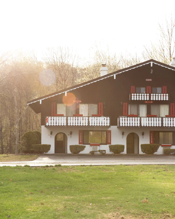 A chalet motel with many decks outside of the rooms