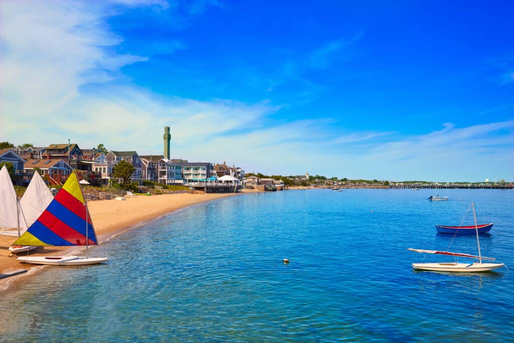 A group of buildings on a beach with very blue water