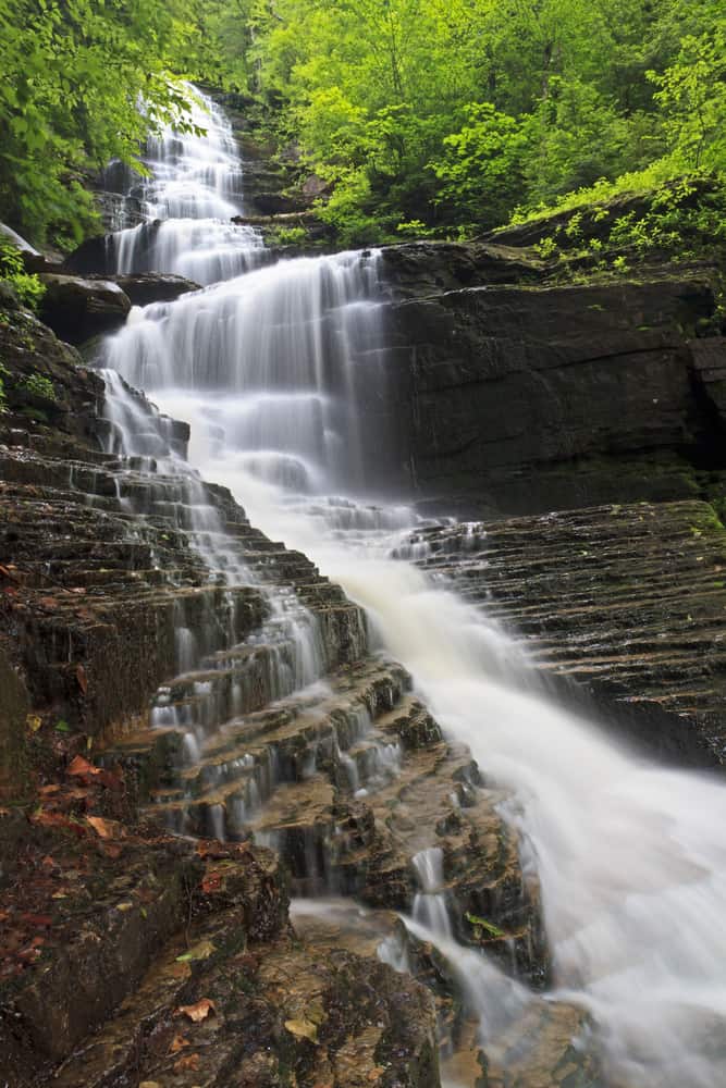 Waterfall cascading down layers of rocks.