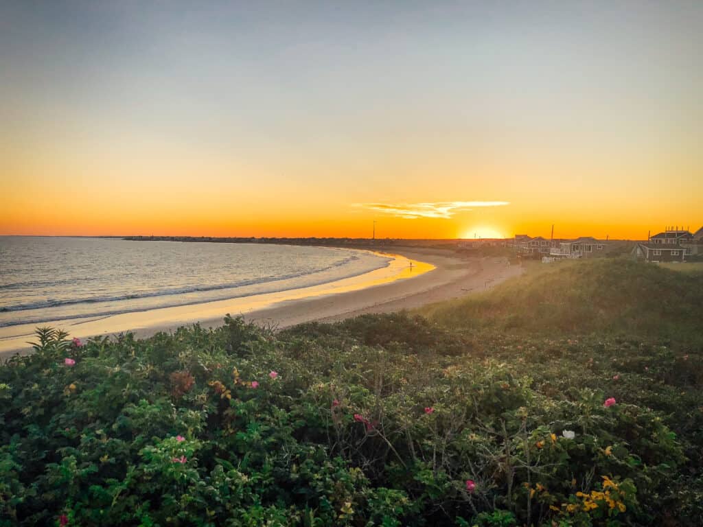 The orange sun sets over one of the most popular beaches in Rhode Island.