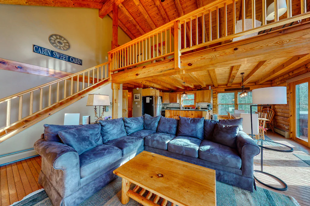 Blue sectional couch in front of steps leading up to a loft