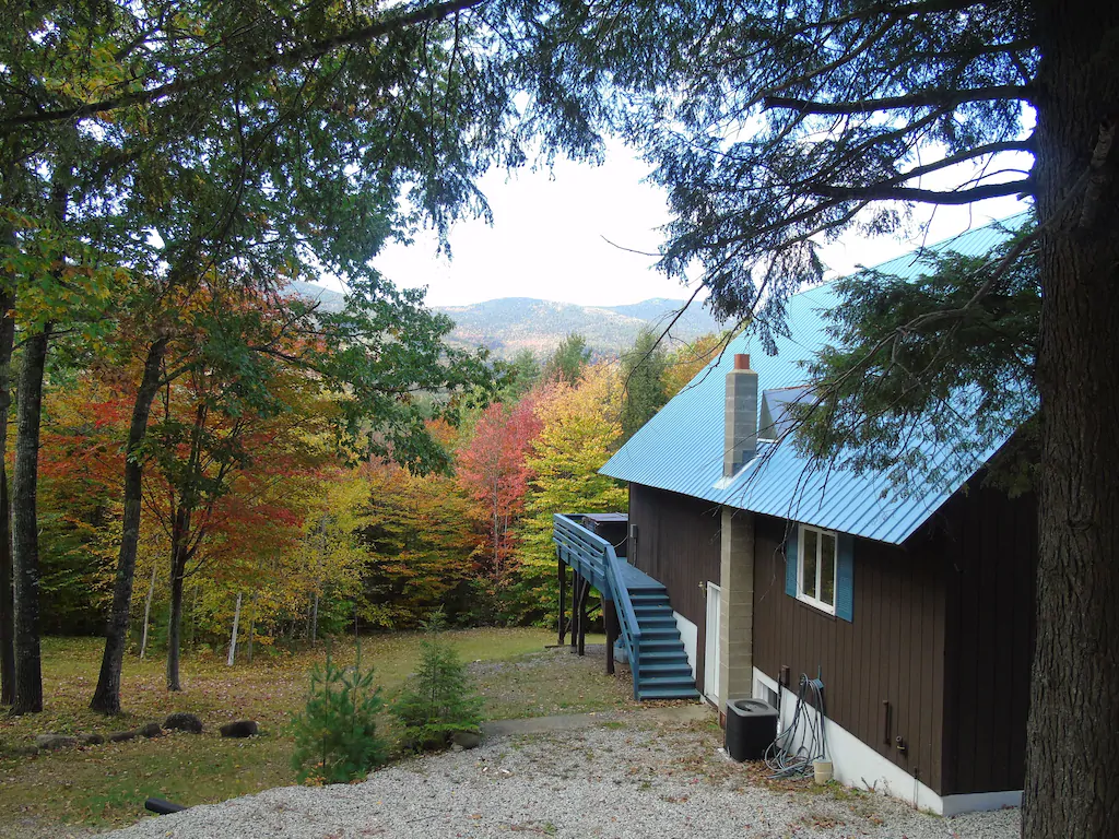 A mountain cabin overlooking fall trees