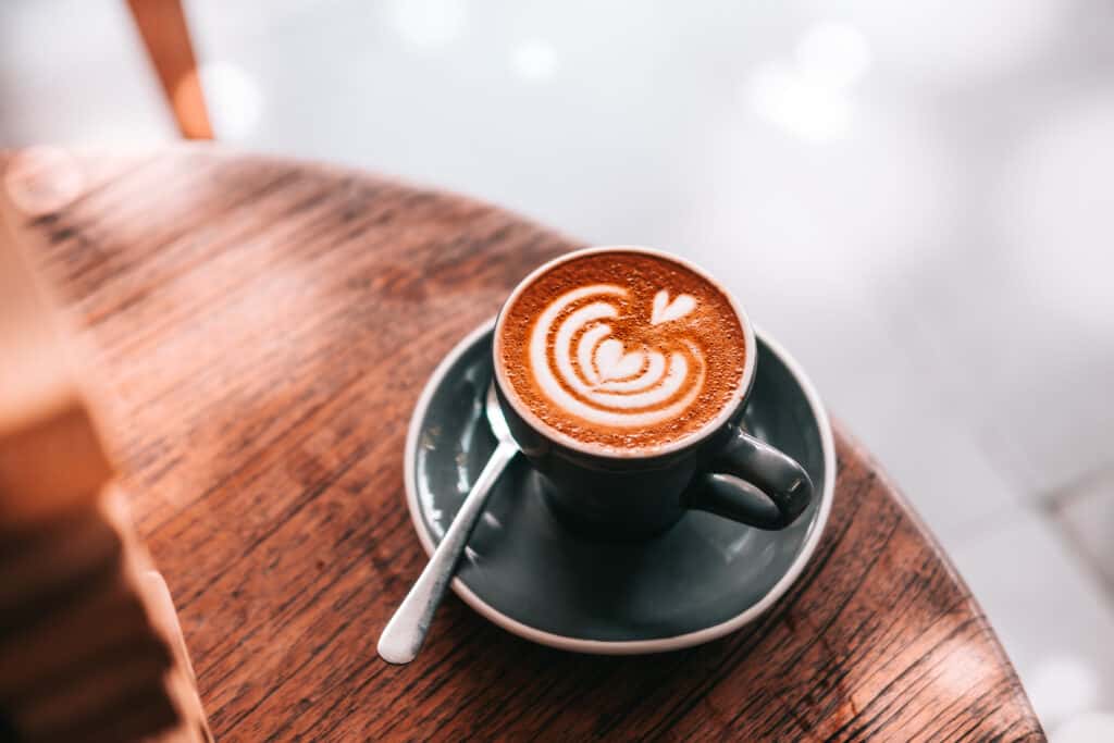 A cup of latte with swirls on top