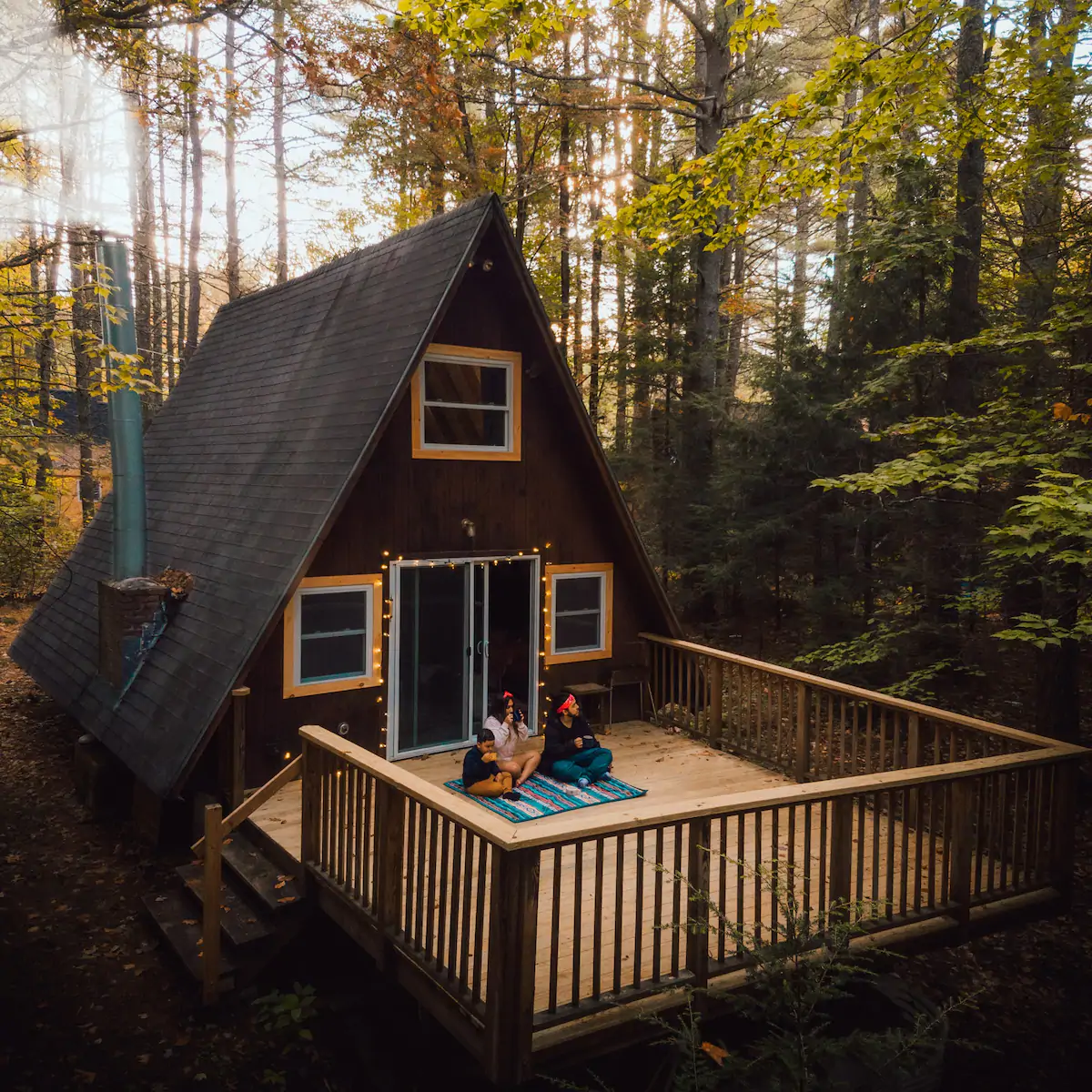 A mountain chalet with a wooden deck