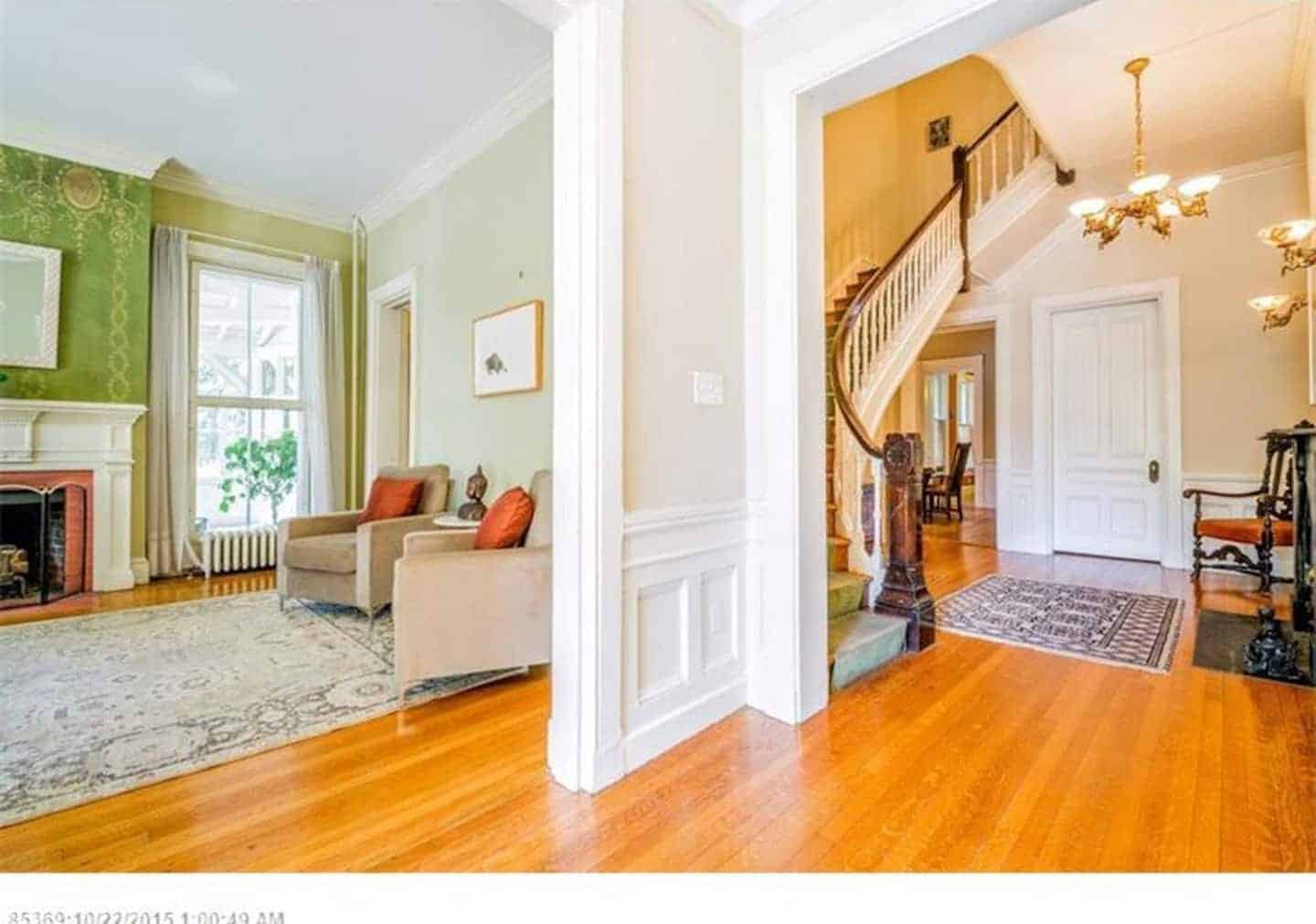 A view of a living room and a view of a staircase