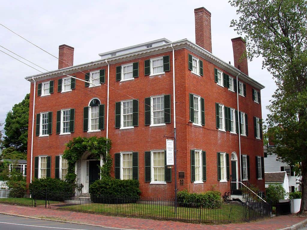 A large brick building with black shutters