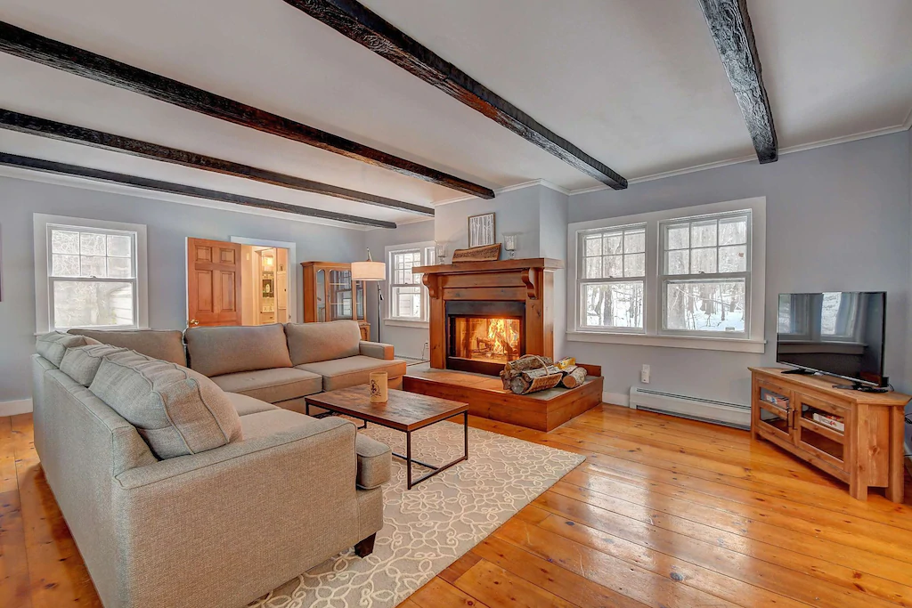 Modern living room with cozy lit fireplace at a New England VRBO