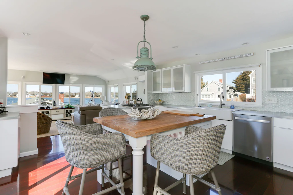 Table and chairs in a white modern kitchen at a Cape Cod VRBO property