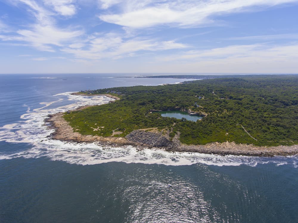 Aerial view of an island, wavy shore and ocean